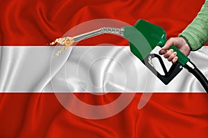 AUSTRIA flag Close-up shot on waving background texture with Fuel pump nozzle in hand. The concept of design solutions. 3d