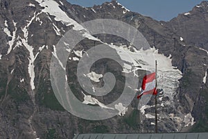 Austria flag waving on Grossglockner Hochalpenstrasse in Austria