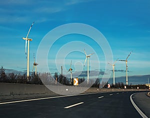 Austria, road to Vienna from Bratislava - 01.14.2024: Wind farm park next to a road in Austria in sunny weather