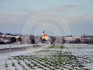 Austria, snow-covered fields and tiny village in winter