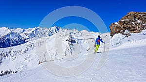 Austria - A skier enjoying the view on the snowy mountains