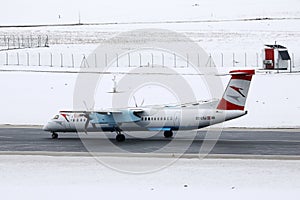 Austrian Airlines plane taxiing in Innsbruck Airport, INN snow