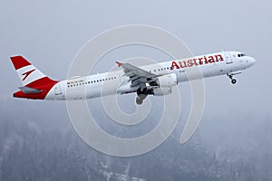 Austrian Airlines plane taking off from Innsbruck Airport