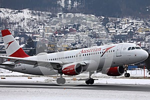 Austrian Airlines plane taking off from Innsbruck Airport