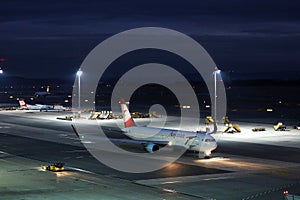 Austrian Airlines plane taxiing in Vienna Airport, VIE, night