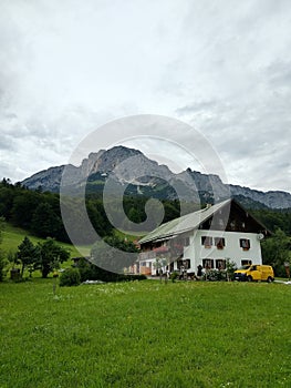 Austrian Alps beautiful house in the middle of nowhere surrounded by mountains and green nature