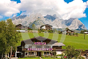 Wilder Kaiser, alpine massif, rugged mountains, green meadows, log cabins, Austria photo