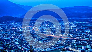 Austrian city and mountains by night