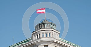 Austrian flag waving in the wind, on top of a building in Vienna, Austria, red and white fabric