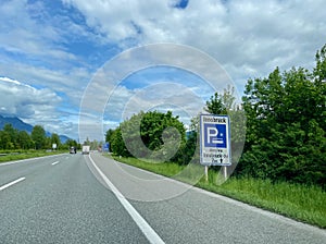 Austrian highway with road sign indicating parking in Innsbruck, Austria.