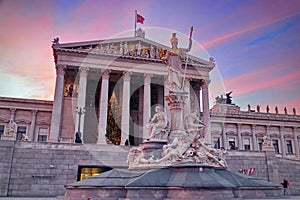 Austrian Parliament Building and Statue of Athena in the spectacular sunset light - landmark attraction in Vienna, Austria