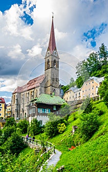 Austrian ski and spa resort Bad Gastein dominated by a parish church and for waterwall flowing through ist city center