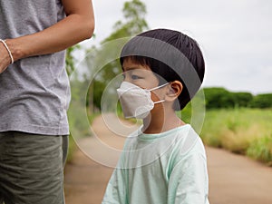 Authentic asian child boy wearing medical face mask to prevent from corona virus or covid-19