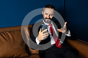 Authentic A bearded businessman is discussing business on the facetime in business negotiations. Video Call. Face time and