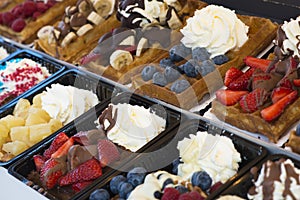 Authentic Belgian waffles with fruits and sweets, delicious dessert concept
