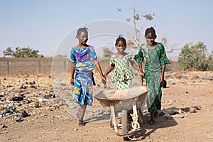 Authentic Black Schoolgirl Transporting pure Water in a village