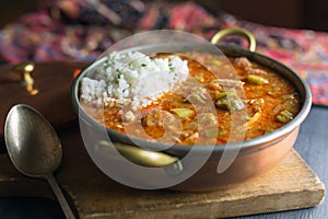 Authentic cajun gumbo with a scoop of rice. Shown with antique silver spoon.