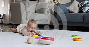 Authentic close up Cute Caucasian Baby Girl 1 year old Playing on floor in living room at home. Slow Motion.