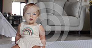 Authentic close up Cute Caucasian Baby Girl 1 year old Playing on floor in living room at home. Slow Motion.