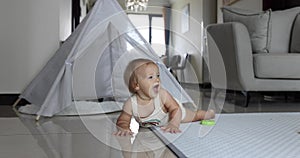 Authentic close up Cute Caucasian Baby Girl 1 year old Playing on floor in living room at home. Slow Motion.