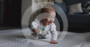 Authentic close up Cute Caucasian Baby Girl six months old learning crawl on floor in living room at home. Slow Motion.