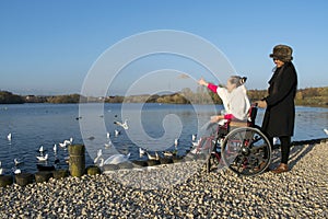 Authentic Disabled Female in Wheelchair With Asian Caregiver, Carer, Real, Healthcare.