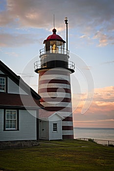 Authentic Fresnel Lens Shines Brightly During Sunset at West Quoddy Head Lighthouse in Maine