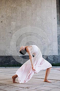 Authentic girl dancing on the street barefoot