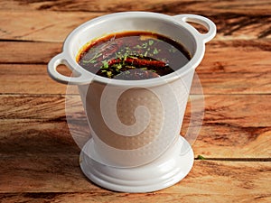 Authentic Indian popular food Dal Tadka Curry or Traditional Indian soup lentils on rustic wooden background. selective focus