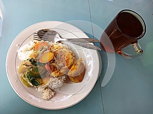 Authentic Indonesian Nasi Rames with Egg and Vegetables
