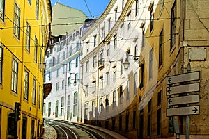 Authentic Lisbon street. The road with the rails along the street goes up for the turn. Lisbon