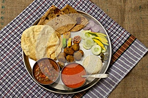 Authentic Maharashtrian lunch thali with Amras and poli, India.