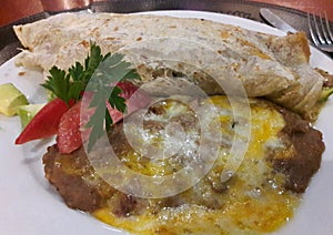 Authentic Mexican Restaurant Vegetarian Food with Beans and Cheese - a Typical Burrito Frijoles Queso Dinner in Mexico photo