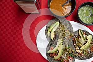 Authentic Mexican tacos accompanied with red and green sauce