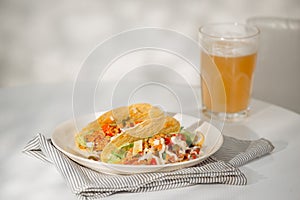 Authentic mexican tacos with beer. Mexican tacos with ground meat, beef, beans, onions and salsa