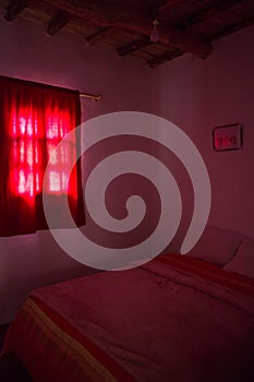 Authentic Moroccan bedroom in traditional riad with red light