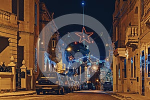 Authentic night street of old city of Malta with Christmas lights decorations and illuminations. Merry Christmas concept