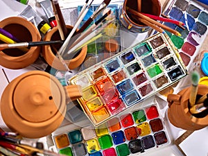 Authentic paint brushes still life on table in art class school.