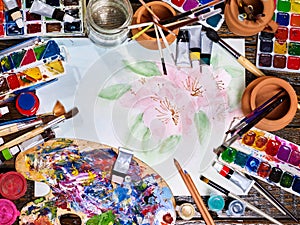 Authentic paint brushes still life on table in art class school.