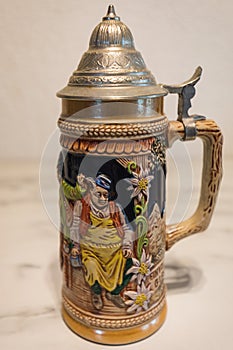 An authentic painted german beer mug on a marble plate