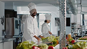 Authentic portrait of african american cook preparing food dish