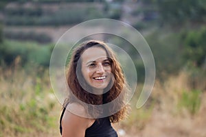 Authentic portrait of smiling brunette female