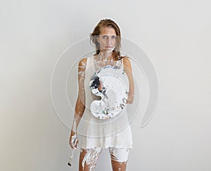 Authentic, proud sexy artist woman, white painted in underskirt, holding Brush and palette