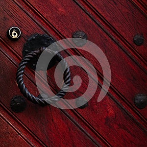 Authentic red wooden front door of an old european house.