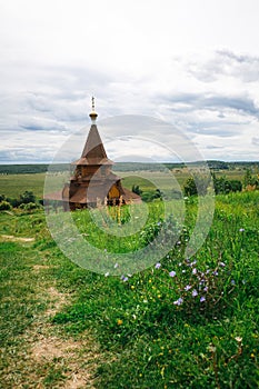 Authentic Russian wooden Church building on a high hill with panoramic views.