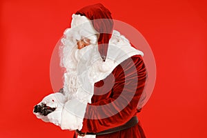 Authentic Santa Claus with game controller on background