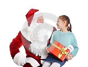 Authentic Santa Claus and little girl with gift box on background