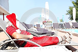 Authentic Santa Claus resting on lounge chair