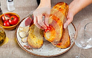 Spanish Pan con Tomate - cook rubs bread with tomatoes photo