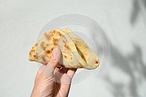 Authentic Sri Lankan Pol Coconut Roti iin hand.